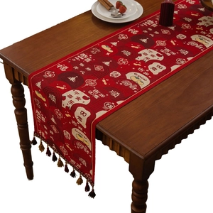 Traditional red Chinese New Year table runner with jacquard patterns and elegant tassels
