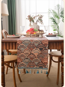 Close-up of bohemian jacquard table runner with ginkgo leaf pattern and tassels