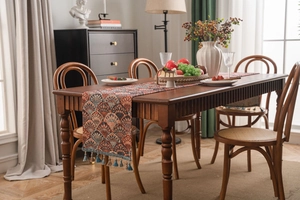 Detail of vintage table runner featuring jacquard ginkgo patterns and elegant tassels