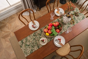 Macro view of thick green jacquard floral table runner with vintage floral patterns