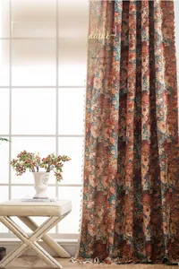 Detail of French floral jacquard curtain with orange blooms and elegant tassel fringe