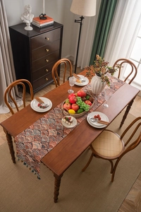 Close-up of thick jacquard table runner with ginkgo leaf patterns and tassels