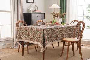 Close-up of vintage floral tablecloth featuring elegant tassel edges and fabric texture