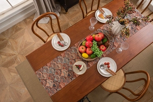 Close-up of bohemian ginkgo leaf jacquard fabric with elegant fringes on wood table