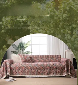 Detail view of woven bohemian sofa cover with jacquard patterns and elegant fringed edges