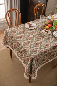 Detailed macro view of American vintage floral jacquard tablecloth with elegant tassels