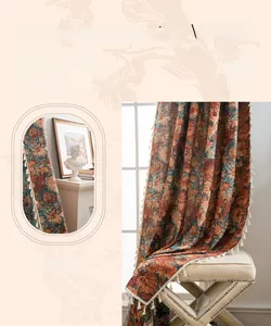 Detail of French jacquard curtains with orange floral embroidery and elegant tassels
