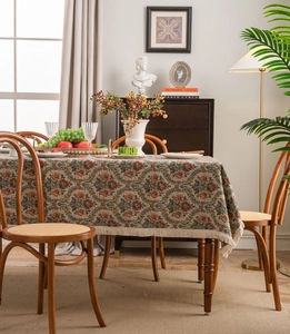 Close-up of vintage floral jacquard tablecloth with elegant hand-made tassels and fringe