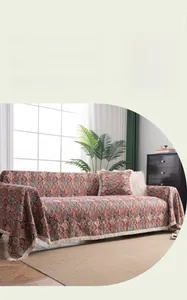 Detailed view of jacquard floral bohemian sofa cover with elegant white tassels