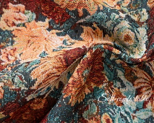 Detailed macro view of heavy floral jacquard fabric with elegant orange flower pattern