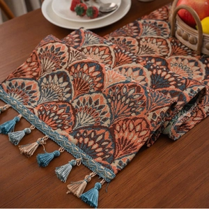 Thick jacquard table runner with ginkgo leaf pattern and tassels in a home setting