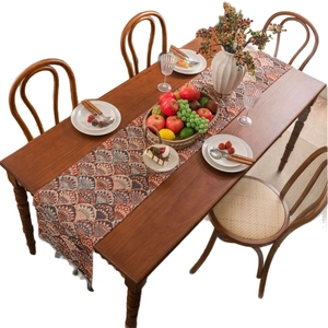 American jacquard table runner with ginkgo patterns and tassels on dark wood table