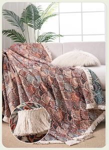 Close-up of bohemian jacquard sofa cover with fringe tassels and geometric patterns