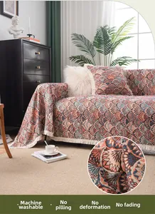 Detail of bohemian sofa throw showing woven texture, fringe edge, and geometric patterns