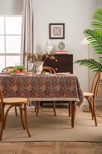 Detailed view of bohemian jacquard tablecloth with fan patterns and cream tassels