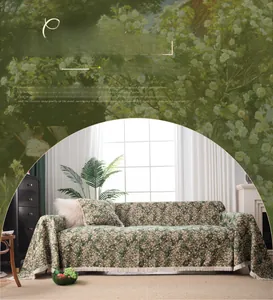 Detail of green floral jacquard sofa cover with fringe trim and premium woven texture