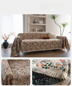 Detail of blue floral chenille sofa cover featuring orange maple leaves and white fringe