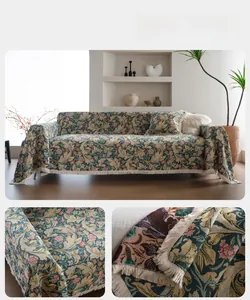 Detail of vintage floral jacquard sofa cover with fringe edges and thick woven texture