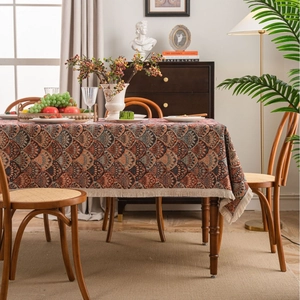 Retro jacquard tablecloth with bohemian wave patterns and tassels on a wooden dining table