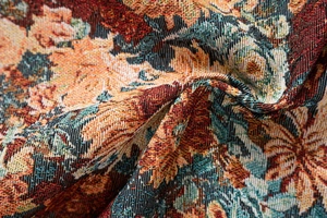 Close-up of thick jacquard fabric showing vintage floral patterns and woven textures