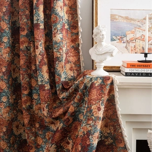Classic orange floral jacquard curtain with tassels in a retro French interior setting