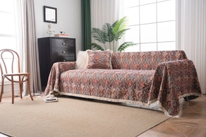 Close-up of bohemian style sofa throw with geometric pattern and white fringe tassels