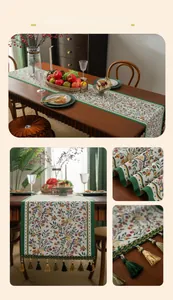 Close-up of vintage floral table runner with green trim and matching tassel accents