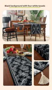 Detail of damask table runner with black background and decorative white tassels