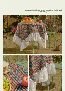Detailed view of colorful jacquard table cloth with elegant white lace ruffled edges