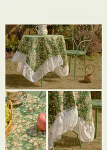 Detail of green floral jacquard tablecloth with elegant white lace ruffle edges