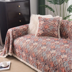 Bohemian knit sofa cover with fringe, vintage shell pattern in red and blue tones