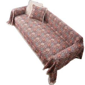 Bohemian style sofa cover with fringe, brick red and blue patterned throw with pillow