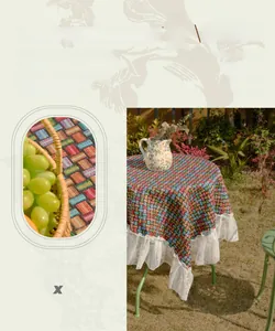 Detail of colorful geometric woven tablecloth featuring elegant white lace ruffle edges