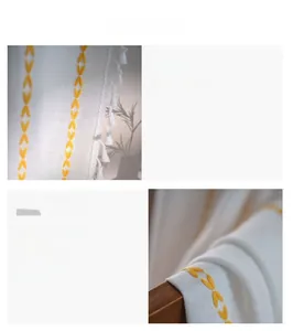 Detail showing yellow embroidered leaves and white fringe on rustic cotton linen curtains