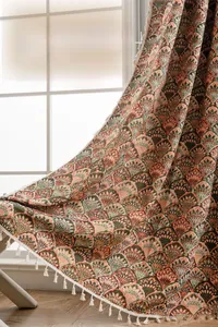 Detail of French floral jacquard curtain with elegant white tassel fringe edges