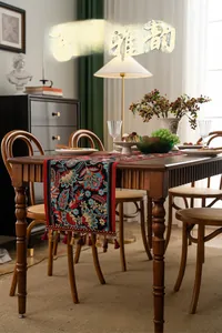 Detail of embroidered phoenix patterns and elegant tassels on a Chinese style table runner