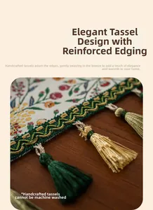 Detailed view of jacquard table runner with floral patterns and green gold tassels