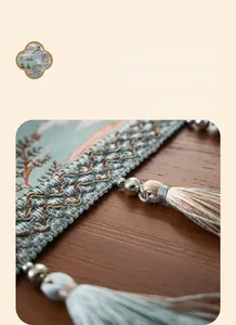 Close-up of Chinese table runner with handmade tassels and delicate metal beads