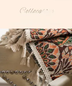 Macro detail of ethnic style jacquard fabric with curved stitching and white tassels