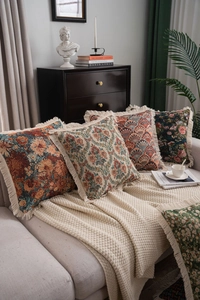 Detailed view of American style jacquard cushions with tassels on a cozy sofa