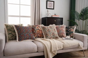 Close-up of vintage jacquard throw pillows with elegant fringe and floral patterns
