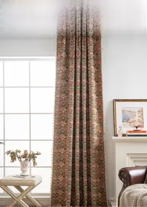 Detail of vintage jacquard curtain featuring floral patterns and white fringe edges