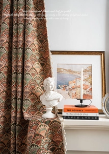 Detail of vintage floral jacquard curtain fabric with artistic fringe and textured weave