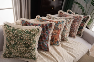 Close-up of thick jacquard pillow fabric with boho patterns and dense fringe trim