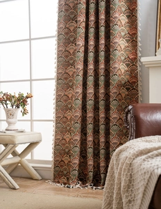 Detail of vintage Art Deco jacquard curtain featuring dense fan patterns and white tassels