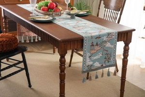 Close-up of jacquard landscape pattern and decorative tassel on a Chinese style table runner