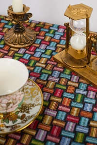 Detailed close-up of multicolor woven jacquard fabric with geometric checkered patterns