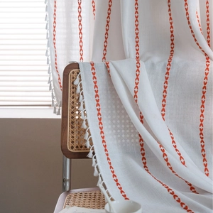 Minimalist white cotton linen curtain with orange embroidery and tassel trim details