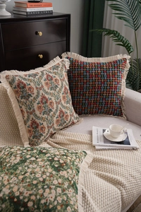 Detailed close-up of American jacquard throw pillows with elegant fringe edges and floral patterns
