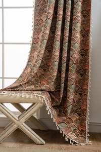 Close-up of retro jacquard curtain with Art Deco feather pattern and white tassel trim